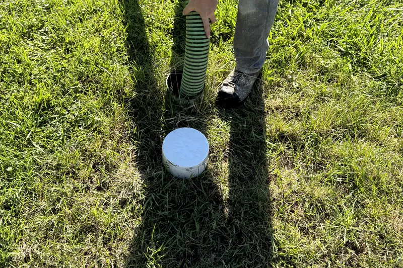 Hands coupling vacuum hose at a riser — no faces