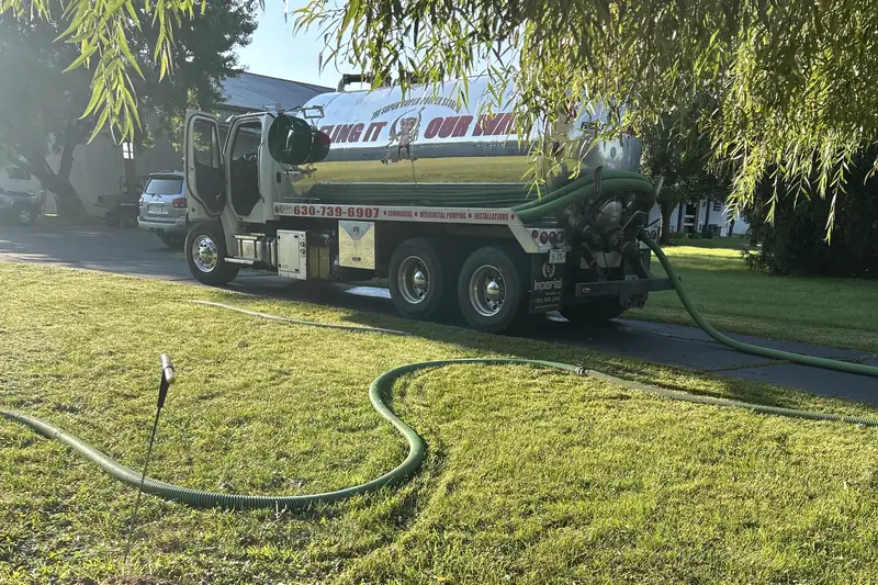 Golden-hour Ability truck with hose across a green lawn